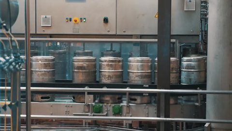 Automatic conveyor line for bottling craft beer into kegs in microbrewery. Brewery manufacturing