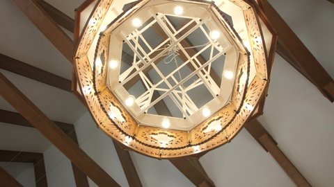 Beautiful Luminous Chandelier with Wooden Elements. Bottom View.
