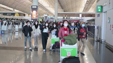 Hong Kong , Lantau Island , China - 02 20 2022: Passengers are seen at Chek Lap Kok International Airport airline check-in counters departure hall in Hong Kong, China.