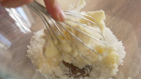 Female hands preparing dough for cookies on table in kitchen close up. Women mixing a piece of butter and sugar. Prepare pastry hand topping. High quality 4k footage