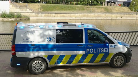 Tallinn Estonia 2021 August 12: A police car manning the side of the river in Tallinn Estonia on a bright sunny day