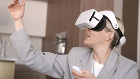 Beautiful woman wearing virtual reality headset. Augmented Reality. Happy cute business woman touch something using modern 3D glasses indoors. Woman playing using VR goggles at home. New technologies