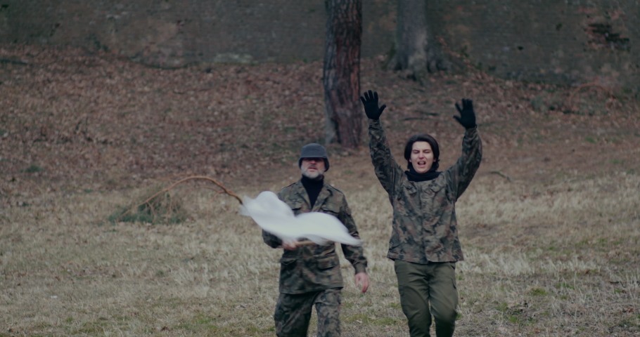 Military Men Waving White Flag And Gesturing During War.