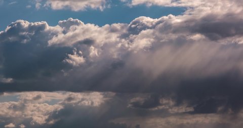 Timelapse of blue sky background with tiny striped clouds before storm with dark clouds