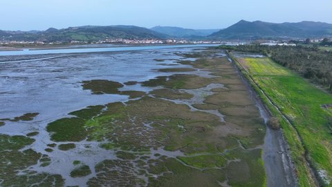 Landscape at low tide of the Santoña, Victoria, Noja and Joyel Marshes seen from a drone. Cantabrian Sea, Cantabria, Spain, Europe
