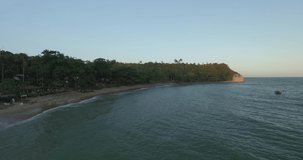 Aerial footage of beach with calm waters and vegetation close to the sea. Espelho beach, discovery coast, Bahia, Brazil