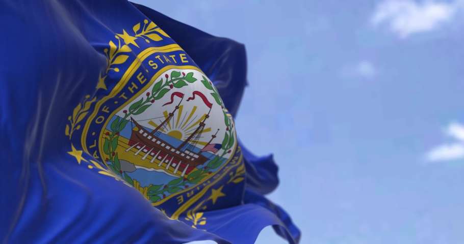 The US state flag of New Hampshire waving in the wind. New Hampshire is a state in the New England region of the United States. Democracy and independence. Seamless loop in slow motion