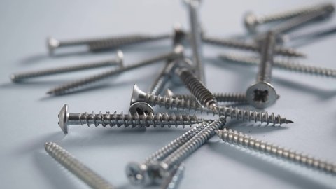 Close up screws with cross head. Carpentry tools. Screwheads.