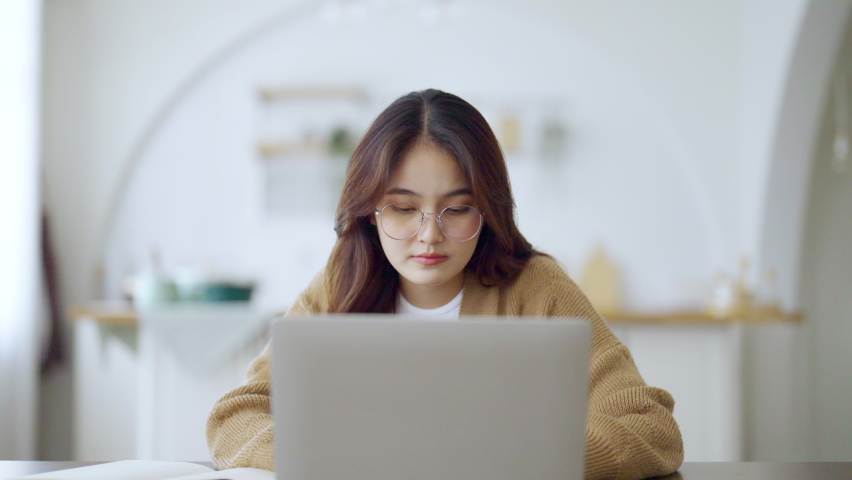 Office syndrome concept. Overworked tired young asian woman feeling headache, having eyesight problem after computer laptop work. Stressed adult business woman suffering from fatigue at home | Shutterstock HD Video #1089170031