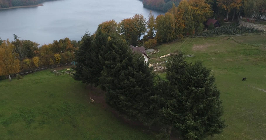 Little scenic isolated house on the riverside in kaszuby region Poland, aerial natural unpolluted remote landscape