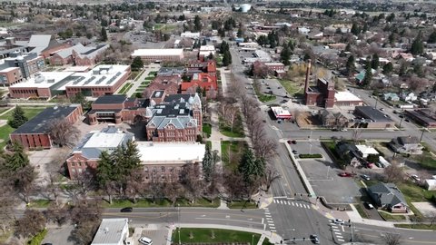 Cinematic 4K aerial drone trucking shot of Central Washington University campus main buildings in the city of Ellensburg, Kittitas County in Western Washington