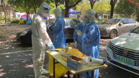 Shanghai,China-April 12th 2022: Chinese health workers working at Covid-19 test site in residential community. Shanghai is in a surge of Coronavirus Omicron virus