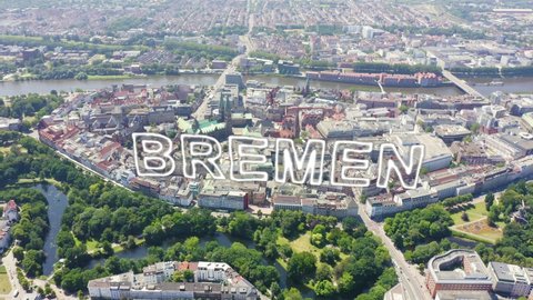Inscription on video. Bremen, Germany. The historic part of Bremen, the old town. Bremen Cathedral ( St. Petri Dom Bremen ). View in flight. Neon white effect text, Aerial View, Departure of the came