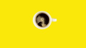 Looping stop motion animation of endless drinking of coffee from white cup on yellow background. Concept of nutrition in modern society . Copy space for your text.
