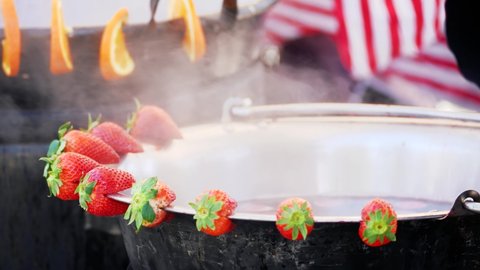 1 mulled strawberry wine in a metal cauldron that evaporates
