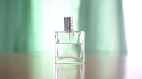 Pick up the perfume bottle from the table