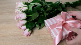 closeup female hands holding box with gift, bouquet of white, pink roses, box with gift with satin ribbon, flowers for professional holiday, concept of mother's, Valentine's day, birthday - Powered by Shutterstock - Get 15% off with code: PIKWIZARD15