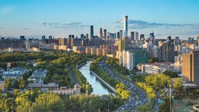 video of CBD cityscape view with car traffic flow on main road beside riverbank in Beijing, China