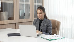Businesswoman presenting business results with business partners, explaining chart during video conference via Laptop in home office, Online Meeting, video call via internet.