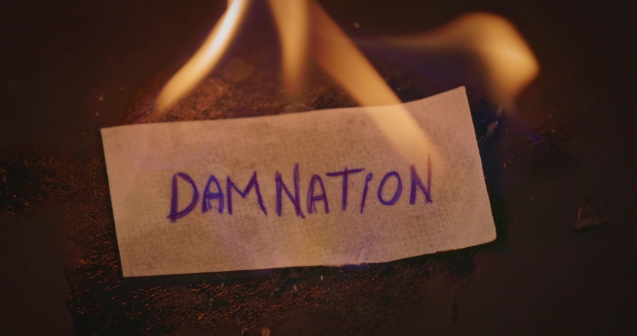 Closeup video of burning paper with DAMNATION written on it