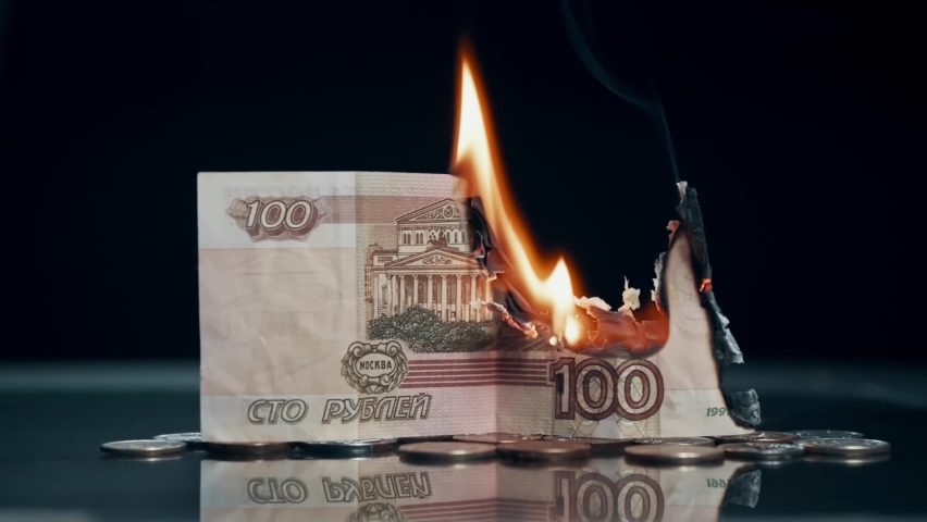 Inflation of Russian ruble. One hundred rubles banknote burns down on black background. Close-up. Royalty-Free Stock Footage #1089183641