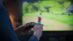 Close Up on Man's Hands at Home, Sitting on a Couch in Stylish Loft Apartment and Playing Arcade Shooter Video Game on Console. Male Using Controller to Play MMO Battle Royale Style Game Online.