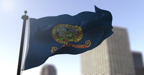 Idaho state waving flag on blurry background, USA state news illustration. Blurry background