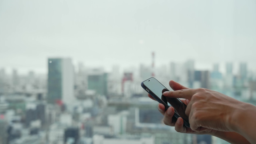 People using a smart phone in front of the city. Royalty-Free Stock Footage #1089186125