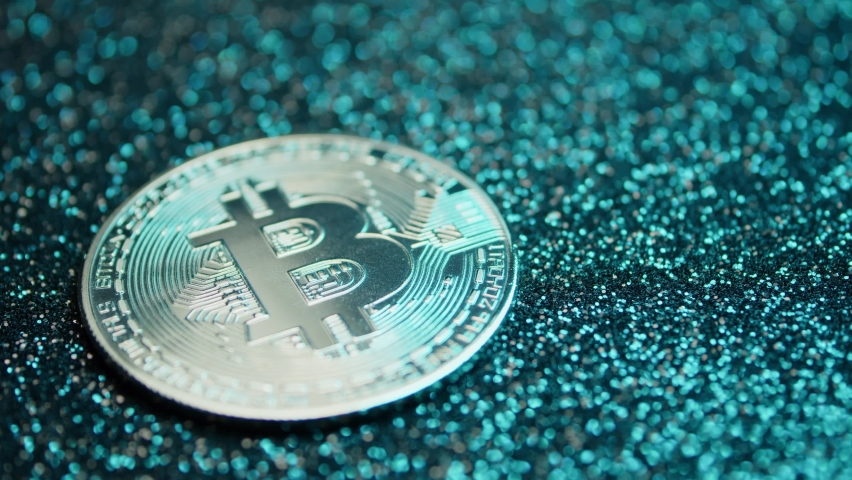 Bitcoin coin on a background that changes colors. Cryptocurrency. Blockchain technologies
