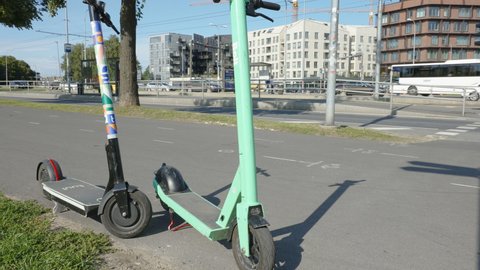 Tallinn Estonia 2021 August 12: Two scooters in different brands in Tallinn Estonia parked on the side of the park