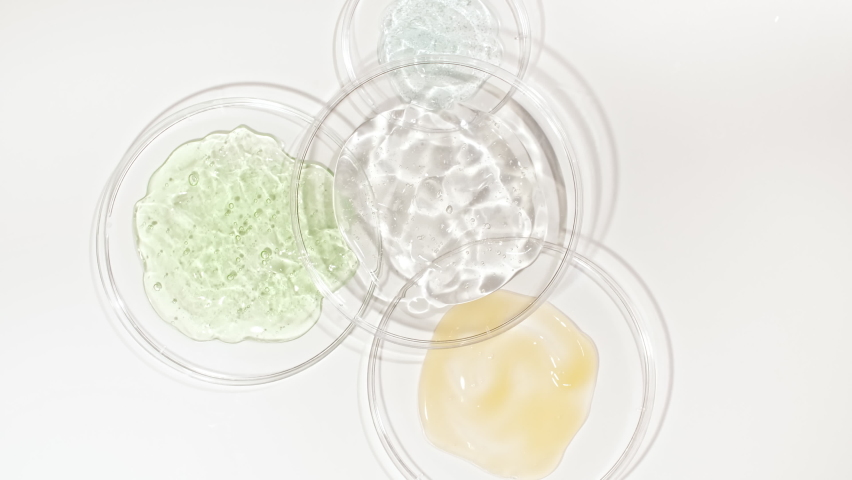 Rotation of Petri dishes with cosmetics samples on a white background. Transparent Gel Fluid, Serum, Cream with Bubbles. Chemical laboratory research. Natural Organic cosmetics, medicine. | Shutterstock HD Video #1089193725