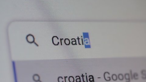 Buenos Aires, Argentina - April 2022: Looking for Useful Information about Croatia on Internet, Searching Internet using Google Search Engine on a Laptop Computer. Close Up. 4K.