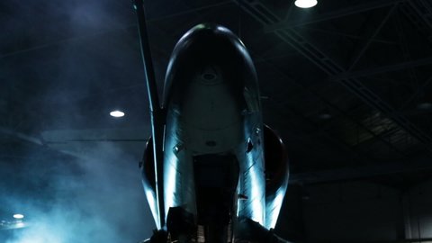 Fighter Jet Inside a Military Hangar Awaiting Deployment. Low Angle View. 