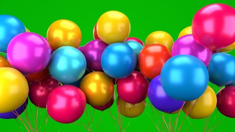 A bunch of multicolored heart-shaped balloons fly into the air. Air balloons on a green background.