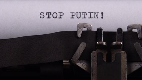 Kyiv, UKRAINE - APRIL 02, 2022: 
Typing phrase "STOP PUTIN !" on retro typewriter.