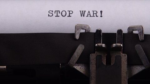 Typing phrase "STOP WAR !" on retro typewriter.