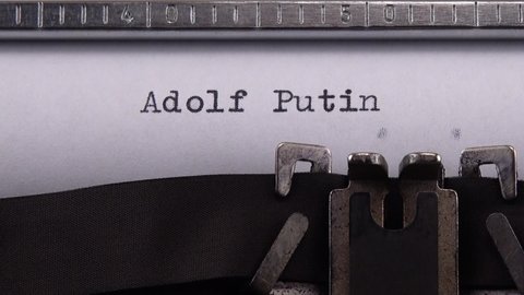 Kyiv, UKRAINE - APRIL 02, 2022:  Typing phrase "Adolf Putin" on retro typewriter.
