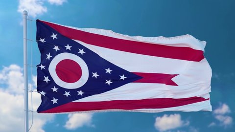 State flag of Ohio waving in the wind. Blue sky background