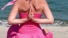 Beautiful young woman is doing exercises yoga on the seashore, Yoga exercises for the mind and body, Video clip