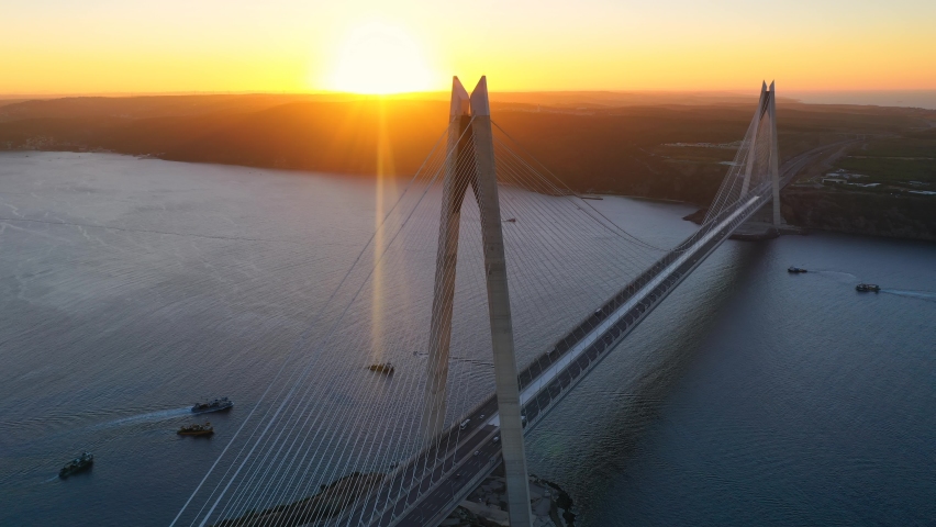 Hyperlapse of YSS Bridge in Istanbul on sunset. Drone turns around 330m long bridge tower located on Poyrazkoy shore. Yavuz Sultan Selim Bridge crosses Bosporus Sea between Europe and Asia. Main span 