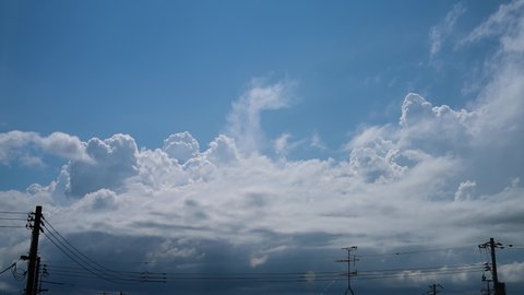 Time-lapse photography of the movement of cumulonimbus clouds in the distance.