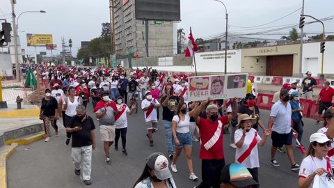 Lima , Lima , Peru - 04 05 2022: A footage of more walking protestants against Peruvian President Pedro Castillo for setting a curfew to stay at home between 2 am and 11:59pm to avoid protests over su