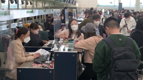 Hong Kong , Lantau Island , China - 02 20 2022: Passengers are seen at the check-in counter airline at the Chek Lap Kok International Airport in Hong Kong, China.