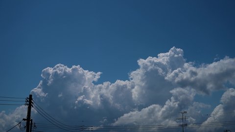 Time-lapse photography of the movement of cumulonimbus clouds in the distance.