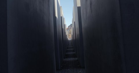 Berlin, Germany - Circa 2021: Holocaust memorial landmark in Berlin, camera spinning between concrete slabs