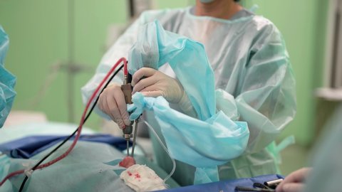 Surgical operation. The concept of surgical treatment. Medical hands performing endoscopic surgery with surgical instruments