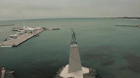 Aerial drone fly over statue town Nessebar Bulgaria. Beautiful Landscape view of small town into the sea at winter cloudy conditions.
