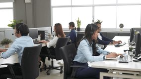 Call center is tired, young adult employee working with headset stretch while working hard, Customer support operator team feeling exhausted and yawning in office, Helpdesk customer services agent - Powered by Shutterstock - Get 15% off with code: PIKWIZARD15