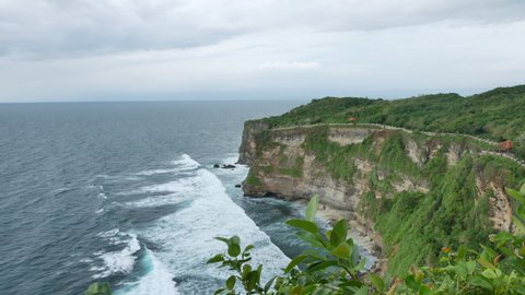 BALI, INDONESIA - JANUARY 22, 2018: Scenic green Uluwatu temple cliff, Bali. 4K, Ultra-wide shot