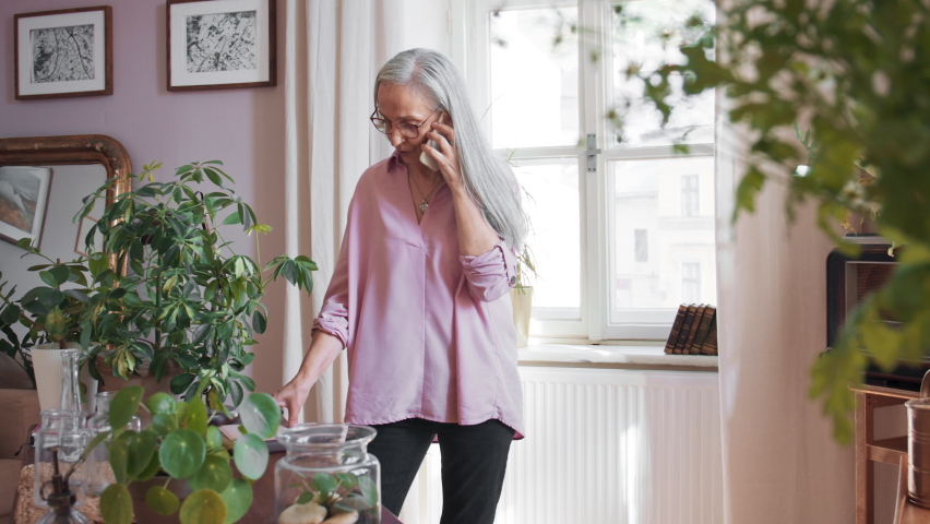 Relaxed senior woman making a phone call at home.